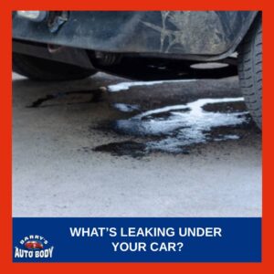 Puddle of fluid under a parked car showing possible engine, coolant, or brake leak